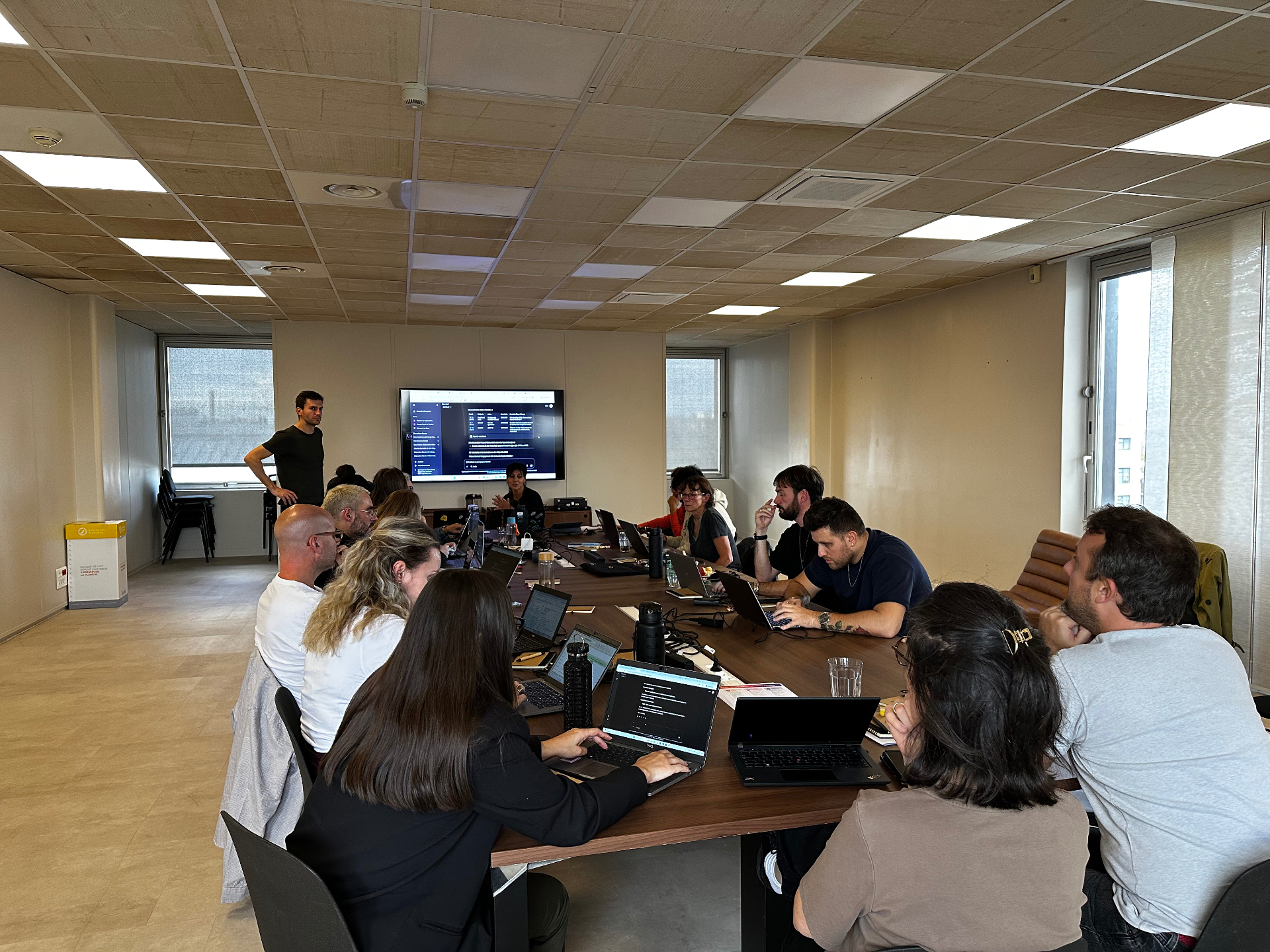 Hackathon session with sticky notes and laptops